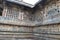 Ornate perforated window and Madanikas, Salabhanjika meaning celestial damsels, on top of the pillars. Chennakeshava temple, Belur