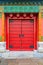 Ornate red wooden door with tile trim and traditional Chinise de