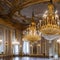 An ornate, Rococo-style ballroom with gilded accents and crystal chandeliers1, Generative AI