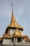 Ornate roof tops decorated with gold of the Wat Trimit temple in Chinatown, Bangkok, Thailand