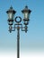 Ornate street lamp on blue sky