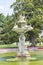 Ornate swan styled fountain in formal garden