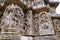 Ornate wall panel reliefs depicting from left dancing Shiva, Krishna as Kaliya-mardana and a deity and dancing Parvati, Kedareshwa