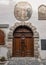 Ornate Wooden door with metal knocker and wall painting Virgin Mary with crowned Baby Jesus, Cesky Krumlov, Czech Republic