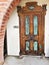 Ornate, wooden door  on old adobe building