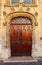 Ornate wooden double door entrance to an old church