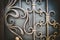 Ornate wrought-iron elements of metal gate decoration