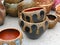 Ornated clay ceramic pattern pot in a workshop