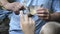 Ornithologist man showing bird to children hand close-up