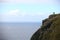 Ornithologist observing birds on a cliff in Norway