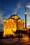 Ortakoy Mosque in Istanbul illuminated by lights at sunset
