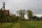 Orthern russian village by the green grass, blue grey, cloudy sky.