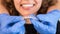 Orthodontist doctor putting silicone invisible transparent braces on woman teeth