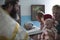 Orthodox baptism of a child. The priest reads a prayer to a child at the rite of baptism