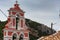 Orthodox bell tower of red color in the Paleokastritsa bay