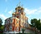 Orthodox christian church with colorful domes at sunset