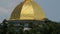 Orthodox Christian church dome topped with golden cross, cloudy sky background