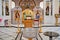 Orthodox church with altar behind iconostasis, pulpit and font for baptism