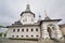 Orthodox church on the background of the cloudy sky. The building is made of stone with crosses on the domes