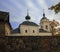 Orthodox church behind natural stone wall against background of the northern autumn sky