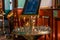 Orthodox church candles in a gold hanging. Church interior in blurry background