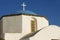 Orthodox church dome and cross in Pyrgos, Santorini, Greece.