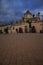 Orthodox church huge architectural complex background focus with city square foreground street tile, vertical cloudy dramatic