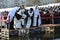 Orthodox Church priest Metropolitan Onufriy blessing people by holy water during ceremony of Great Blessing Of Waters