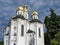 The Orthodox Church of St. Catherine in Chernihiv, Ukraine, emerges as a pristine white church adorned with gleaming golden domes