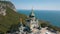 Orthodox church on a steep cliff. Sea and mountains on a background. Aerial view of Foros Church on a mountain over the