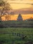 Orthodox Church at sunset among blooming gardens in spring.