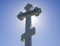 Orthodox cross against the blue sky and the sun. Cross in the ba