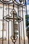 Orthodox cross forged in fence of church. Christian religion pattern. Entrance to the temple. Religious holiday or Sunday service