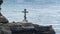 Orthodox cross mounted on rocky shore of the Black Sea near Sevastopol in Crimea