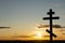 Orthodox cross on in the sunbeams of the sunset. Faith and faith concept. Spiritual moment