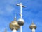 Orthodox crucifixes on golden cupolas in blue sky