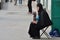 Orthodox elderly woman nun in a black robe collects a donation