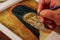 Orthodox icon painter. Closeup image of a painter`s hand