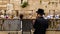 An Orthodox Jew uses a cell phone in front of the Western Wall in Jerusalem