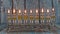 Orthodox jewish light a hanukkah menorah with olive oil candles.