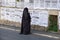 Orthodox jewish `Taliban women` read street poster in jewish quarter