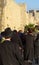 Orthodox Jews walking along the city wall of Jerusalem towards Jaffa Gate