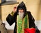 Orthodox monk hood blesses people outside
