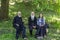 Orthodox monks and parishioner woman in the park of Velika Remeta Monastery in Fruska Gora, Serbia.