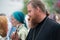 Orthodox priest giving the cross for kissing to the parishioner