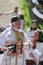 Orthodox priest and people in traditional national costumes - a village in Maramures, Romania