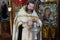 Orthodox priest to prepare for church service. The priest lights a candle