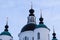 Orthodox white stone chirch against blue cloudy sky. Four (4) domes with crosses on top