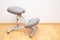 Orthopedic ergonomic kneeling chair close-up on home wall background, back health care