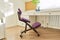 Orthopedic ergonomic kneeling chair in the interior of children`s room, home office